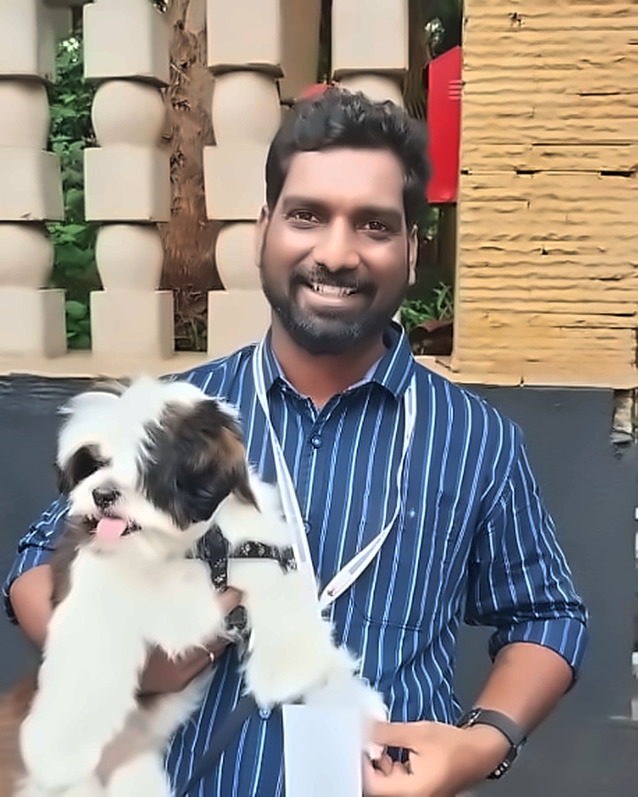 Dr. Srinivas Pulpa, Chief Veterinarian holding a Shih Tzu dog at Pulpa's Veterinary Clinic