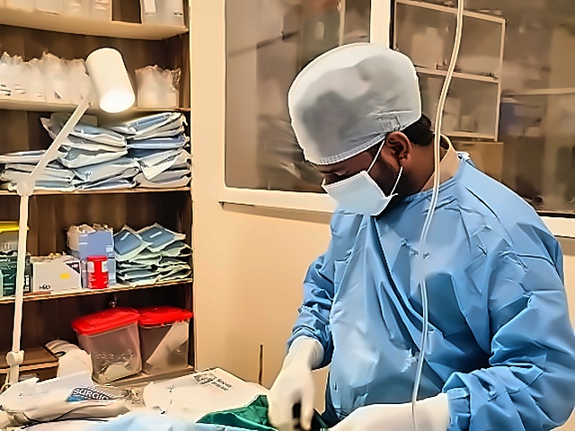 Dr. Srinivas Pulpa performing surgical procedure in the operating theatre at Pulpa's Veterinary Clinic